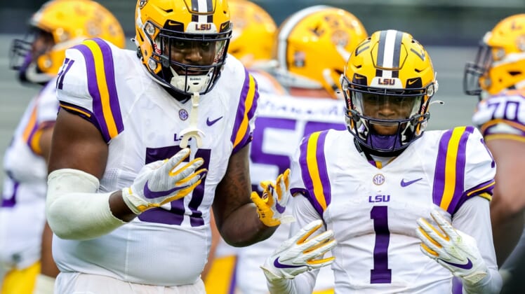 Apr 17, 2021; Baton Rouge, Louisiana, USA;  LSU Tigers offensive tackle Dare Rosenthal (51) and LSU Tigers wide receiver Kayshon Boutte (1) pose for the camera on a time out during the first half of the annual Purple and White spring game at Tiger Stadium. Mandatory Credit: Stephen Lew-USA TODAY Sports