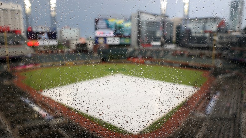 Apr 24, 2021; Atlanta, Georgia, USA; Rain drops are shown on a piece of glass as a tarp is shown on the infield before the start of the game between the Arizona Diamondbacks and the Atlanta Braves at Truist Park. Mandatory Credit: Jason Getz-USA TODAY Sports