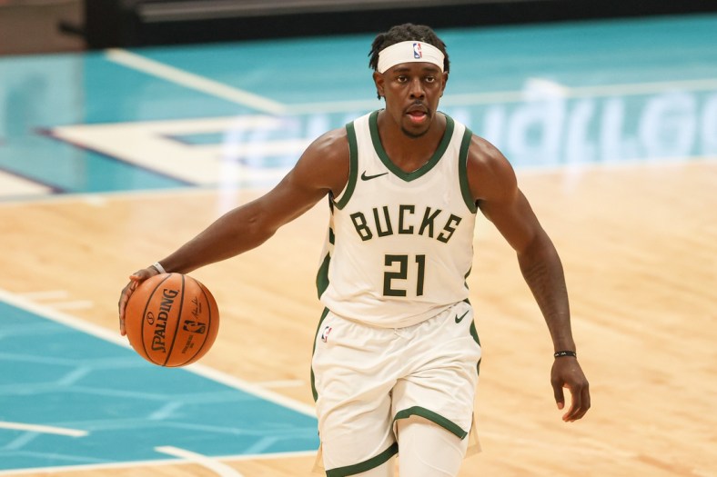 Apr 27, 2021; Charlotte, North Carolina, USA; Milwaukee Bucks guard Jrue Holiday (21) brings the ball up court against the Charlotte Hornets in the second half at Spectrum Center. The Milwaukee Bucks won 114-104. Mandatory Credit: Nell Redmond-USA TODAY Sports