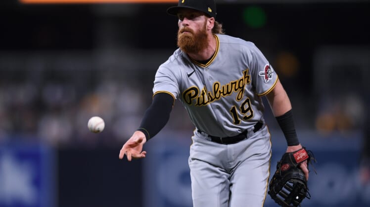 May 3, 2021; San Diego, California, USA; Pittsburgh Pirates first baseman Colin Moran (19) tosses the ball to first base during the eighth inning against the San Diego Padres at Petco Park. Mandatory Credit: Orlando Ramirez-USA TODAY Sports