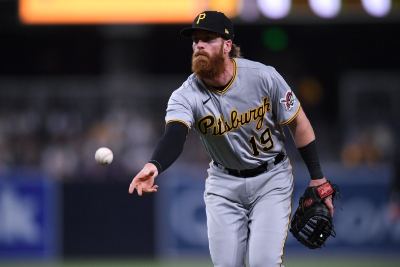 May 3, 2021; San Diego, California, USA; Pittsburgh Pirates first baseman Colin Moran (19) tosses the ball to first base during the eighth inning against the San Diego Padres at Petco Park. Mandatory Credit: Orlando Ramirez-USA TODAY Sports