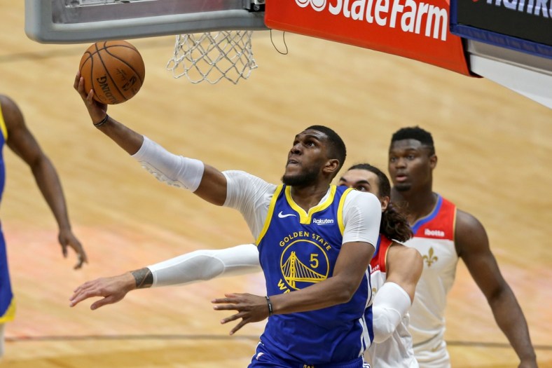 May 4, 2021; New Orleans, Louisiana, USA; Golden State Warriors forward Kevon Looney (5) shoots the ball past New Orleans Pelicans center Steven Adams (12) in the first quarter at the Smoothie King Center. Mandatory Credit: Chuck Cook-USA TODAY Sports