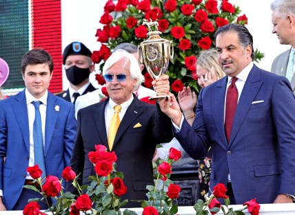 May 1, 2021; Louisville, Kentucky, USA; Medina Spirit owner Amr F. Zedan (right) and trainer Bob Baffert hold the trophy after winning the 147th running of the Kentucky Derby at Churchill Downs. Mandatory Credit: Jim Owens-USA TODAY Sports