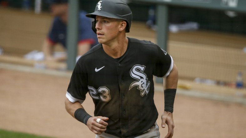 May 19, 2021; Minneapolis, Minnesota, USA; Chicago White Sox left fielder Jake Lamb (23) returns to the dugout after scoring against the Minnesota Twins in the sixth inning at Target Field. Mandatory Credit: Bruce Kluckhohn-USA TODAY Sports