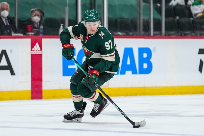 May 20, 2021; Saint Paul, Minnesota, USA; Minnesota Wild forward Kirill Kaprizov (97) carries the puck during the second period in game three of the first round of the 2021 Stanley Cup Playoffs against the Vegas Golden Knights at Xcel Energy Center. Mandatory Credit: Brace Hemmelgarn-USA TODAY Sports
