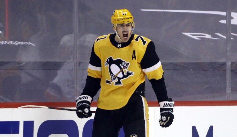 May 24, 2021; Pittsburgh, Pennsylvania, USA; Pittsburgh Penguins center Evgeni Malkin (71) reacts after scoring a power play goal against the New York Islanders during the first period in game five of the first round of the 2021 Stanley Cup Playoffs at PPG Paints Arena. Mandatory Credit: Charles LeClaire-USA TODAY Sports