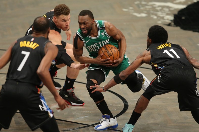 May 25, 2021; Brooklyn, New York, USA; Boston Celtics point guard Kemba Walker (8) drives to the basket against Brooklyn Nets power forward Kevin Durant (7) and power forward Blake Griffin (2) and point guard Kyrie Irving (11) during the first quarter of game two of the first round of the 2021 NBA Playoffs at Barclays Center. Mandatory Credit: Brad Penner-USA TODAY Sports