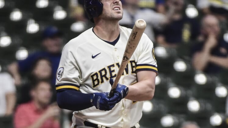 May 25, 2021; Milwaukee, Wisconsin, USA; Milwaukee Brewers third baseman Travis Shaw (21) watches his solo home run during the seventh inning against the San Diego Padres at American Family Field. Mandatory Credit: Benny Sieu-USA TODAY Sports