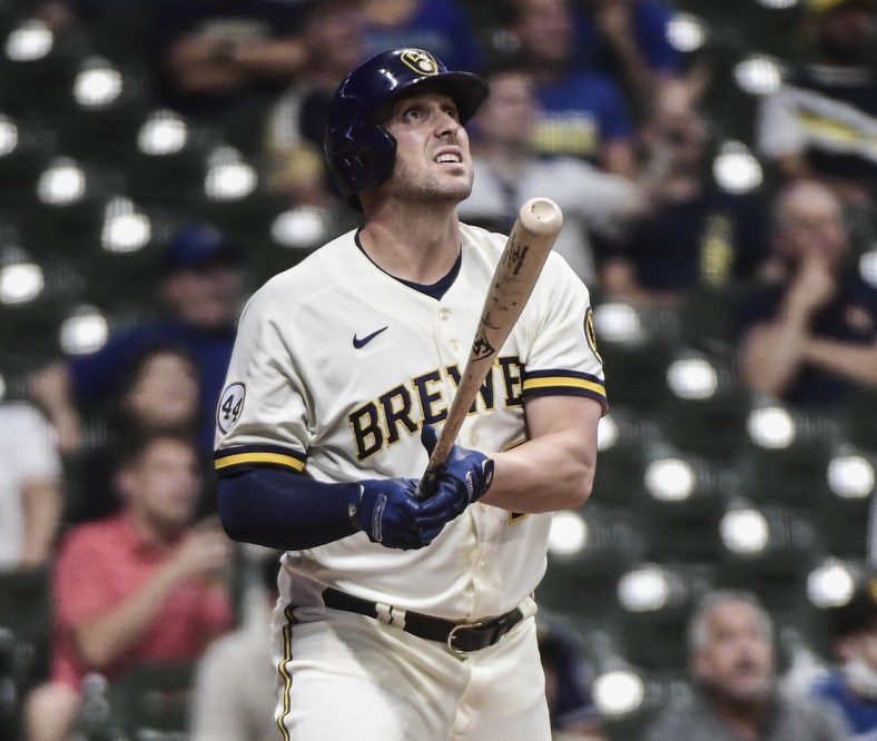 May 25, 2021; Milwaukee, Wisconsin, USA; Milwaukee Brewers third baseman Travis Shaw (21) watches his solo home run during the seventh inning against the San Diego Padres at American Family Field. Mandatory Credit: Benny Sieu-USA TODAY Sports