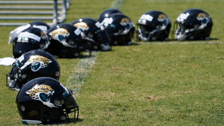 May 27, 2021; Jacksonville, Florida, USA; Jacksonville Jaguars players helmets sit pin the field during OTA at the Dream Finders Homes Practice Complex. Mandatory Credit: Jasen Vinlove-USA TODAY Sports