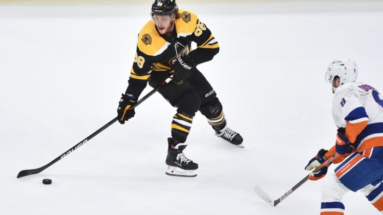 May 29, 2021; Boston, MA, USA; Boston Bruins right wing David Pastrnak (88) controls the puck while New York Islanders defenseman Noah Dobson (8) defends during the third period in game one of the second round of the 2021 Stanley Cup Playoffs at TD Garden. Mandatory Credit: Bob DeChiara-USA TODAY Sports