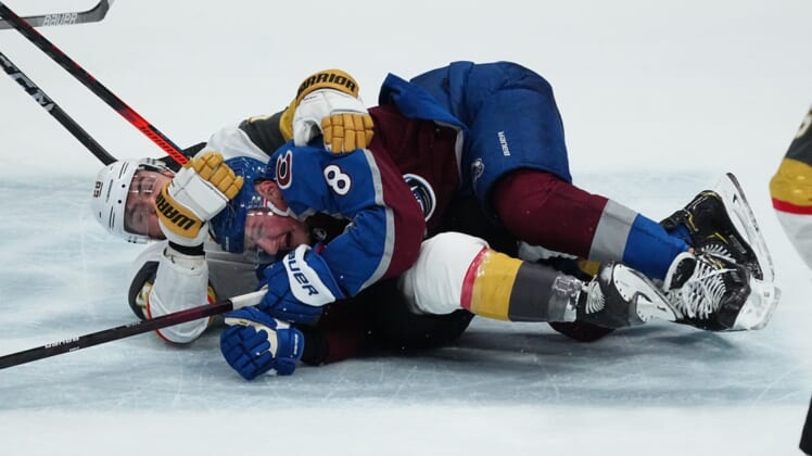 May 30, 2021; Denver, Colorado, USA; Vegas Golden Knights left wing William Carrier (28) takes down Colorado Avalanche defenseman Cale Makar (8) in the second period of game one in the second round of the 2021 Stanley Cup Playoffs at Ball Arena. Mandatory Credit: Ron Chenoy-USA TODAY Sports