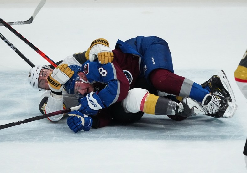 May 30, 2021; Denver, Colorado, USA; Vegas Golden Knights left wing William Carrier (28) takes down Colorado Avalanche defenseman Cale Makar (8) in the second period of game one in the second round of the 2021 Stanley Cup Playoffs at Ball Arena. Mandatory Credit: Ron Chenoy-USA TODAY Sports