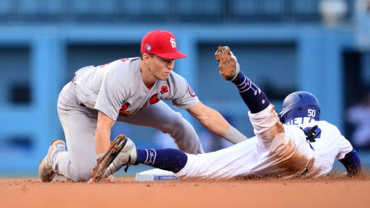 May 31, 2021; Los Angeles, California, USA; Los Angeles Dodgers right fielder Mookie Betts (50) is caught stealing second against St. Louis Cardinals second baseman Tommy Edman (19) to end the third inning at Dodger Stadium. Mandatory Credit: Gary A. Vasquez-USA TODAY Sports