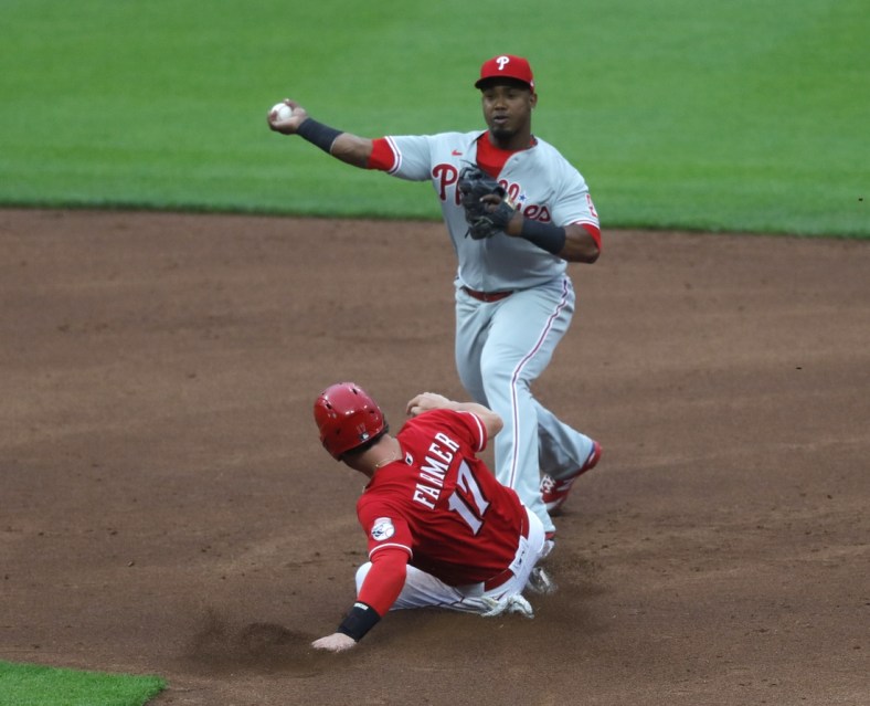 Jun 1, 2021; Cincinnati, Ohio, USA; Cincinnati Reds shortstop Kyle Farmer (17) is forced out a second as  Philadelphia Phillies second baseman Jean Segura (2) throws to first to complete a double play during the second inning at Great American Ball Park. Mandatory Credit: David Kohl-USA TODAY Sports