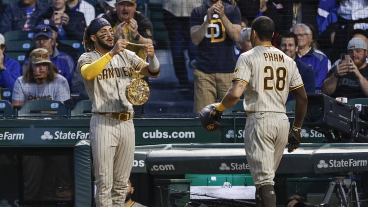 Jun 1, 2021; Chicago, Illinois, USA; San Diego Padres left fielder Tommy Pham (28) receives a chain swag from shortstop Fernando Tatis Jr. (23) after hitting a two-run home run against the Chicago Cubs during the fifth inning at Wrigley Field. Mandatory Credit: Kamil Krzaczynski-USA TODAY Sports