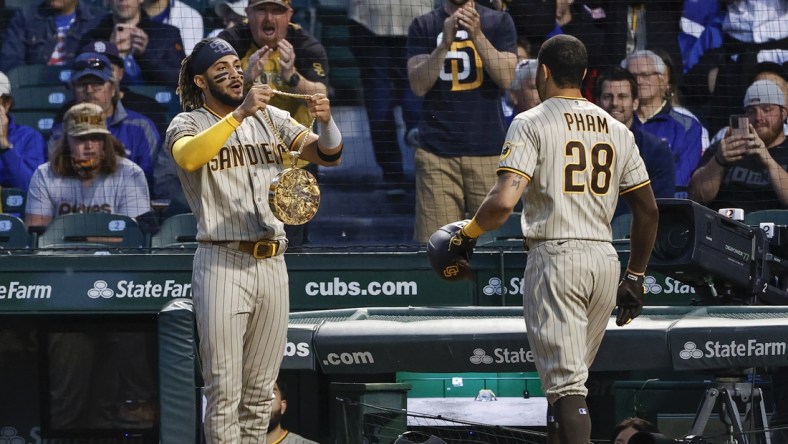 Jun 1, 2021; Chicago, Illinois, USA; San Diego Padres left fielder Tommy Pham (28) receives a chain swag from shortstop Fernando Tatis Jr. (23) after hitting a two-run home run against the Chicago Cubs during the fifth inning at Wrigley Field. Mandatory Credit: Kamil Krzaczynski-USA TODAY Sports