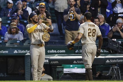 Jun 1, 2021; Chicago, Illinois, USA; San Diego Padres left fielder Tommy Pham (28) receives a chain swag from shortstop Fernando Tatis Jr. (23) after hitting a two-run home run against the Chicago Cubs during the fifth inning at Wrigley Field. Mandatory Credit: Kamil Krzaczynski-USA TODAY Sports