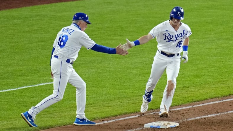 Jun 1, 2021; Kansas City, Missouri, USA; Kansas City Royals left fielder Andrew Benintendi (16) is congratulated by first base coach Rusty Kuntz (18) after hitting a grand slam against the Pittsburgh Pirates during the fifth inning at Kauffman Stadium. Mandatory Credit: Jay Biggerstaff-USA TODAY Sports