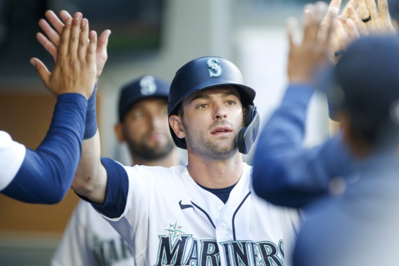 Jun 1, 2021; Seattle, Washington, USA; Seattle Mariners designated hitter Mitch Haniger (17) is greeted in the dugout after scoring a run against the Oakland Athletics during the third inning at T-Mobile Park. Mandatory Credit: Joe Nicholson-USA TODAY Sports