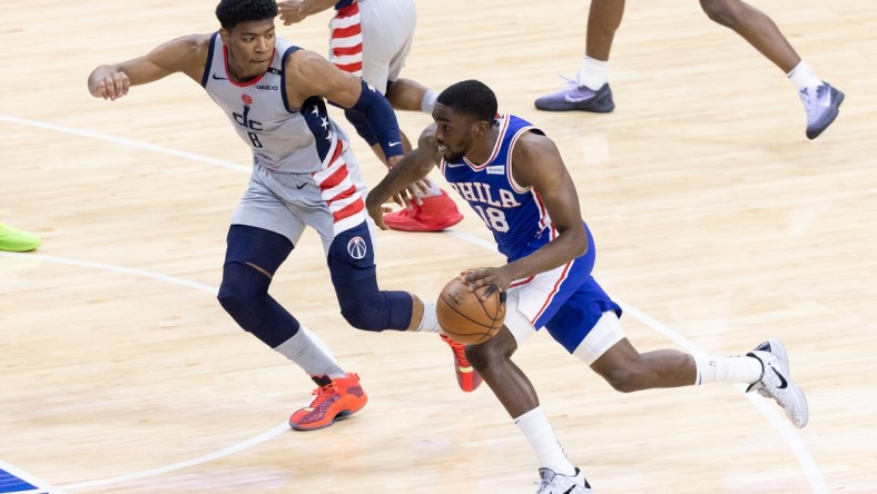 Jun 2, 2021; Philadelphia, Pennsylvania, USA; Philadelphia 76ers guard Shake Milton (18) dribbles the ball against Washington Wizards forward Rui Hachimura (8) during the second quarter in game five of the first round of the 2021 NBA Playoffs at Wells Fargo Center. Mandatory Credit: Bill Streicher-USA TODAY Sports