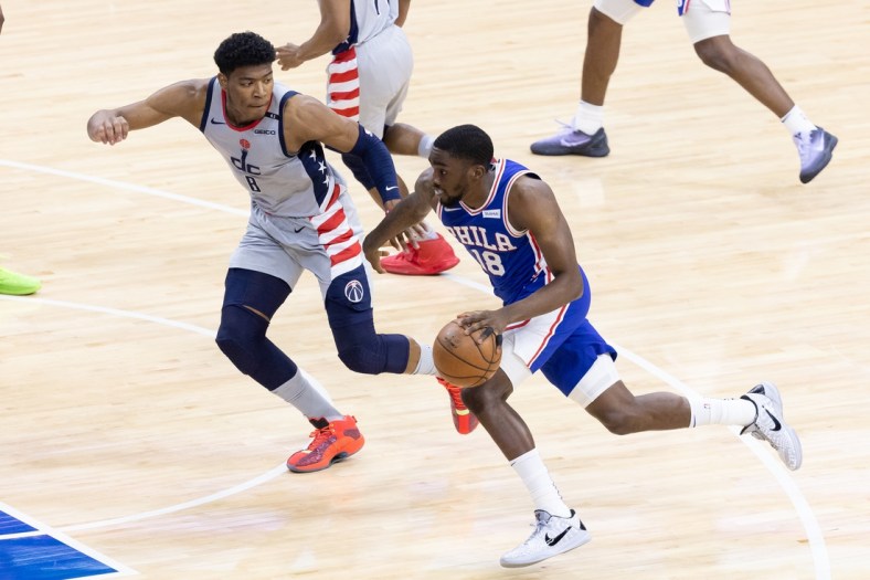 Jun 2, 2021; Philadelphia, Pennsylvania, USA; Philadelphia 76ers guard Shake Milton (18) dribbles the ball against Washington Wizards forward Rui Hachimura (8) during the second quarter in game five of the first round of the 2021 NBA Playoffs at Wells Fargo Center. Mandatory Credit: Bill Streicher-USA TODAY Sports