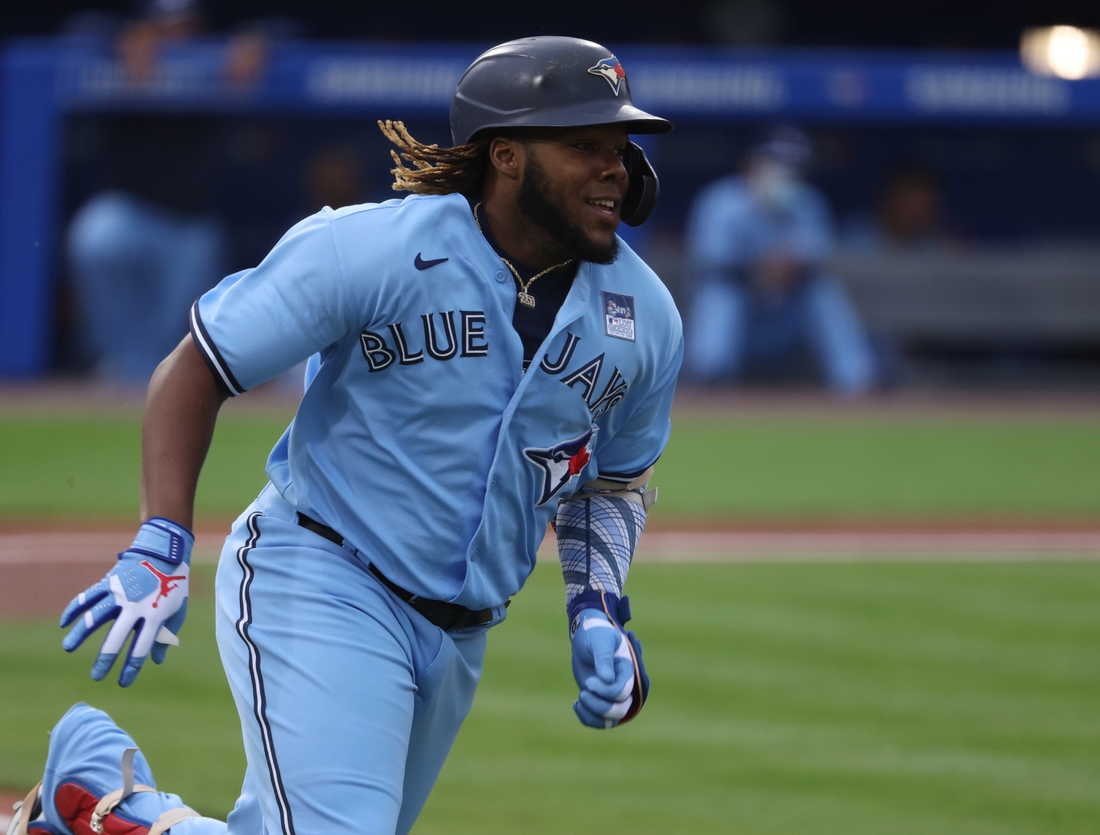 Jun 2, 2021; Buffalo, New York, USA; Toronto Blue Jays designated hitter Vladimir Guerrero Jr. (27) runs the bases after hitting a triple during the first inning against the Miami Marlins at Sahlen Field. Mandatory Credit: Timothy T. Ludwig-USA TODAY Sports