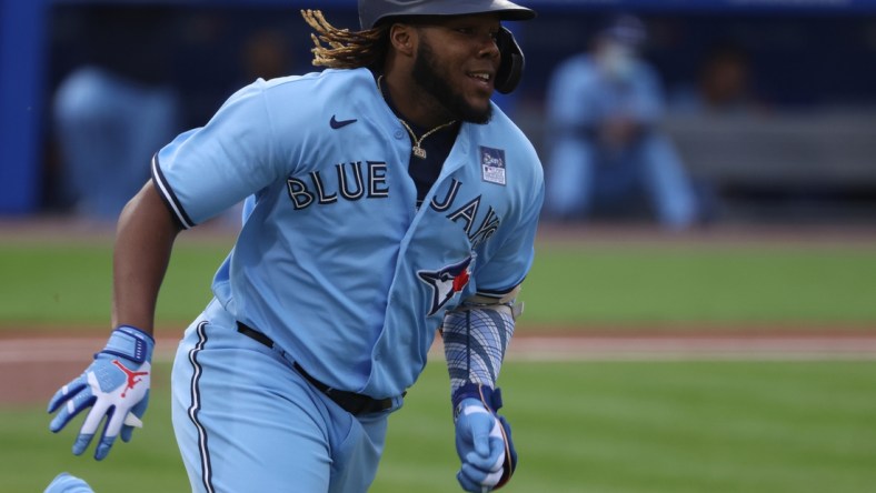 Jun 2, 2021; Buffalo, New York, USA; Toronto Blue Jays designated hitter Vladimir Guerrero Jr. (27) runs the bases after hitting a triple during the first inning against the Miami Marlins at Sahlen Field. Mandatory Credit: Timothy T. Ludwig-USA TODAY Sports