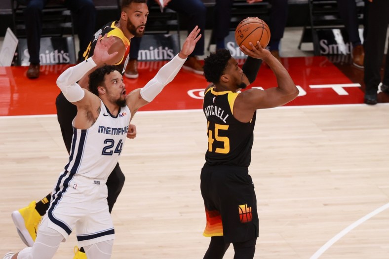 Jun 2, 2021; Salt Lake City, Utah, USA; Utah Jazz guard Donovan Mitchell (45) gets away from Memphis Grizzlies forward Dillon Brooks (24) and shoots the ball during the first quarter in game five of the first round of the 2021 NBA Playoffs at Vivint Arena. Mandatory Credit: Chris Nicoll-USA TODAY Sports