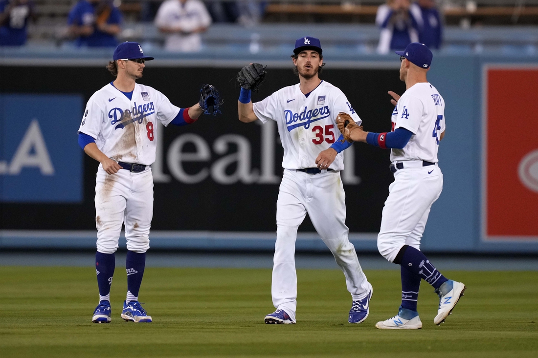 Jun 2, 2021; Los Angeles, California, USA; Los Angeles Dodgers left fielder baseman Zach McKinstry (8) celebrates with center fielder Cody Bellinger (35) and right fielder Matt Beaty (45) after defeating the the St. Louis Cardinals at Dodger Stadium. Mandatory Credit: Kirby Lee-USA TODAY Sports