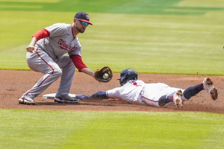 Jun 3, 2021; Cumberland, Georgia, USA; Atlanta Braves second baseman Ozzie Albies (1) steals second base ahead of a tag by Washington Nationals shortstop Jordy Mercer (27) during the first inning at Truist Park. Mandatory Credit: Dale Zanine-USA TODAY Sports