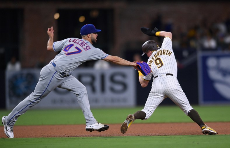 Jun 4, 2021; San Diego, California, USA; San Diego Padres second baseman Jake Cronenworth (9) is called out on a fielder s choice as New York Mets starting pitcher Joey Lucchesi (47) attempts the tag during the fourth inning at Petco Park. Mandatory Credit: Orlando Ramirez-USA TODAY Sports