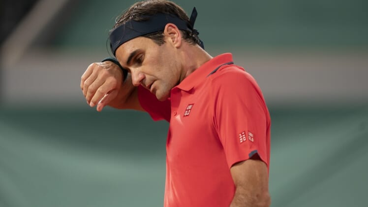 Jun 5, 2021; Paris, France; Roger Federer (SUI) wipes his brow during his match against Dominik Koepfer (GER) on day seven of the French Open at Stade Roland Garros. Mandatory Credit: Susan Mullane-USA TODAY Sports