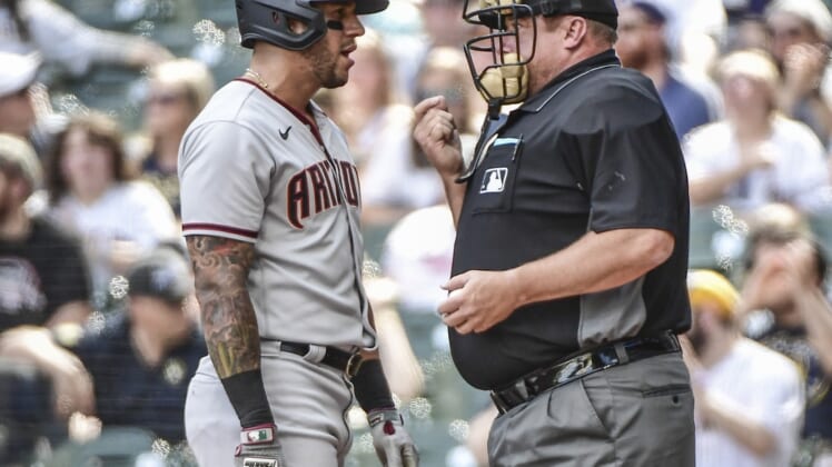 Jun 5, 2021; Milwaukee, Wisconsin, USA; Arizona Diamondbacks left fielder David Peralta (left) talks with home plate umpire Bruce Dreckman (right) after being called out on strikes during the third inning against the Milwaukee Brewers at American Family Field. Mandatory Credit: Benny Sieu-USA TODAY Sports