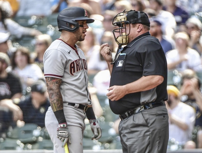 Jun 5, 2021; Milwaukee, Wisconsin, USA; Arizona Diamondbacks left fielder David Peralta (left) talks with home plate umpire Bruce Dreckman (right) after being called out on strikes during the third inning against the Milwaukee Brewers at American Family Field. Mandatory Credit: Benny Sieu-USA TODAY Sports