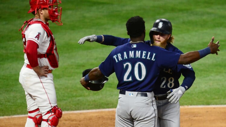 Jun 5, 2021; Anaheim, California, USA; Seattle Mariners designated hitter Jake Fraley (28) is greeted by left fielder Taylor Trammell (20) after hitting a grand slam home run against the Los Angeles Angels during the fourth inning at Angel Stadium. Mandatory Credit: Gary A. Vasquez-USA TODAY Sports