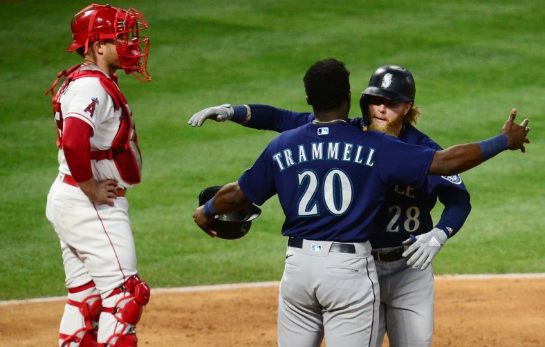 Jun 5, 2021; Anaheim, California, USA; Seattle Mariners designated hitter Jake Fraley (28) is greeted by left fielder Taylor Trammell (20) after hitting a grand slam home run against the Los Angeles Angels during the fourth inning at Angel Stadium. Mandatory Credit: Gary A. Vasquez-USA TODAY Sports