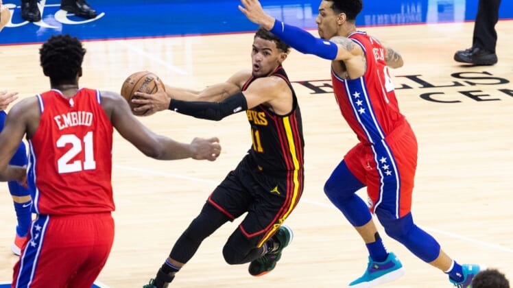 Jun 6, 2021; Philadelphia, Pennsylvania, USA; Atlanta Hawks guard Trae Young (11) drives against Philadelphia 76ers forward Danny Green (14) and center Joel Embiid (21) during the third quarter of game one in the second round of the 2021 NBA Playoffs at Wells Fargo Center. Mandatory Credit: Bill Streicher-USA TODAY Sports