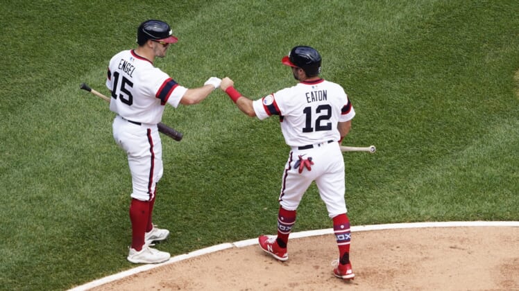 Jun 6, 2021; Chicago, Illinois, USA; Chicago White Sox right fielder Adam Eaton (12) is greeted by center fielder Adam Engel (15) after scoring against the Detroit Tigers during the second inning at Guaranteed Rate Field. Mandatory Credit: David Banks-USA TODAY Sports