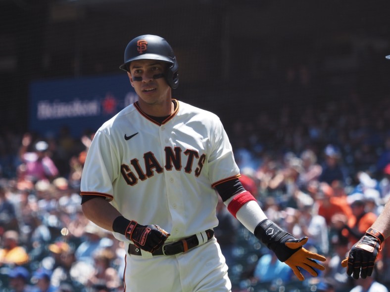 Jun 6, 2021; San Francisco, California, USA; San Francisco Giants shortstop Mauricio Dubon (1) high fives a teammate after scoring a run against the Chicago Cubs during the second inning at Oracle Park. Mandatory Credit: Kelley L Cox-USA TODAY Sports