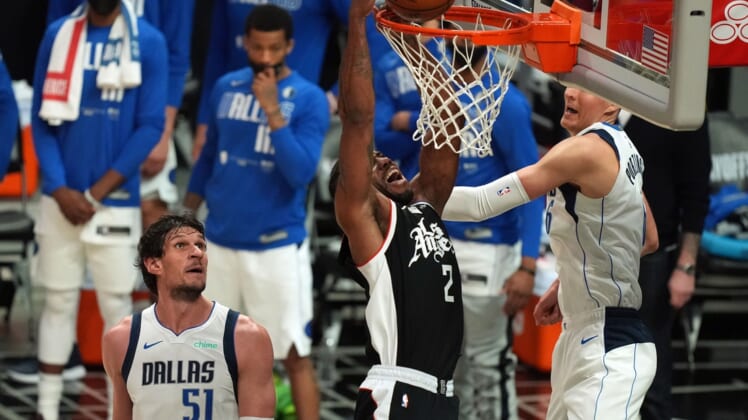 Jun 6, 2021; Los Angeles, California, USA; Los Angeles Clippers forward Kawhi Leonard (2) moves in for a basket against Dallas Mavericks center Kristaps Porzingis (6) and center Boban Marjanovic (51) during the second half in game seven of the first round of the 2021 NBA Playoffs. at Staples Center. Mandatory Credit: Kirby Lee-USA TODAY Sports