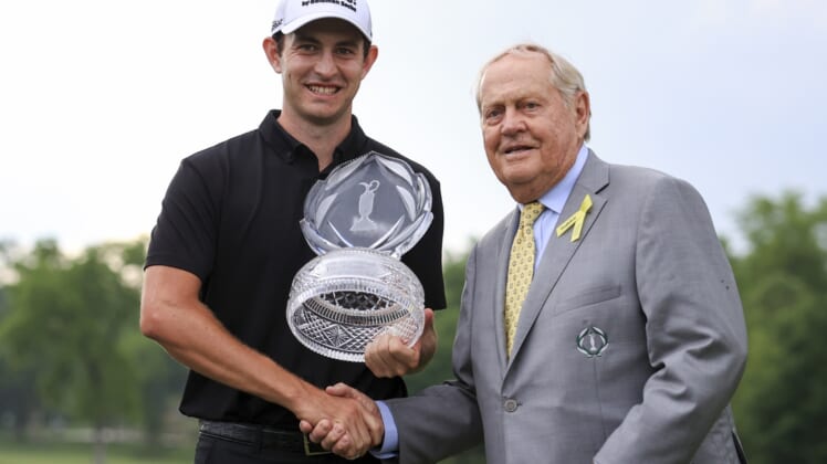 Jun 6, 2021; Dublin, Ohio, USA; Patrick Cantlay (left) holds the trophy as he shakes hands with Jack Nicklaus with after winning the Memorial Tournament golf tourney. Mandatory Credit: Aaron Doster-USA TODAY Sports