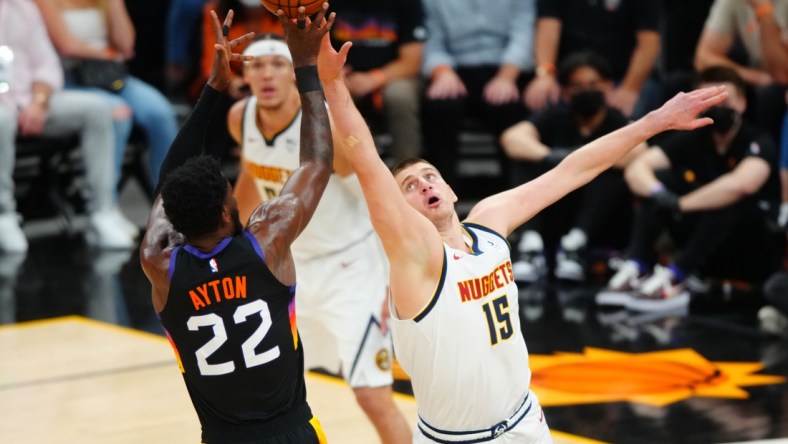 Jun 7, 2021; Phoenix, Arizona, USA; Denver Nuggets center Nikola Jokic (15) defends against Phoenix Suns center Deandre Ayton (22) in the first half during game one in the second round of the 2021 NBA Playoffs at Phoenix Suns Arena. Mandatory Credit: Mark J. Rebilas-USA TODAY Sports