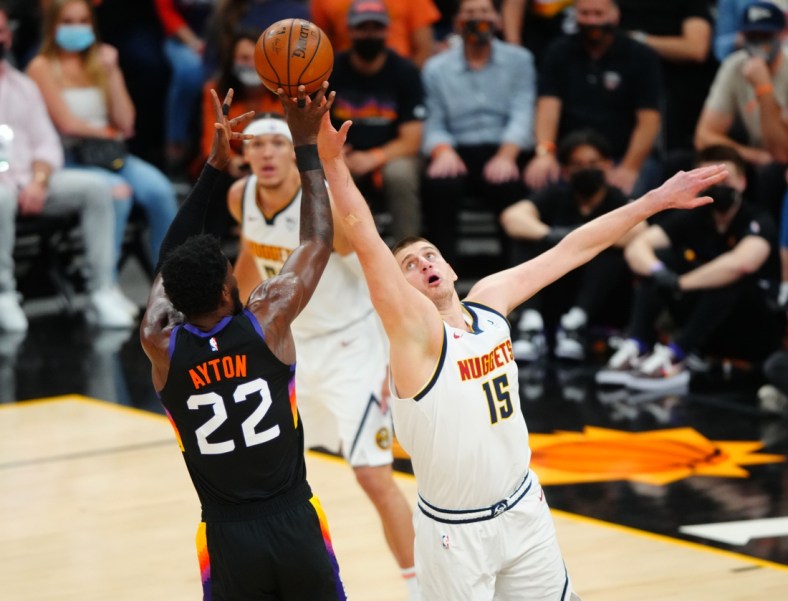 Jun 7, 2021; Phoenix, Arizona, USA; Denver Nuggets center Nikola Jokic (15) defends against Phoenix Suns center Deandre Ayton (22) in the first half during game one in the second round of the 2021 NBA Playoffs at Phoenix Suns Arena. Mandatory Credit: Mark J. Rebilas-USA TODAY Sports