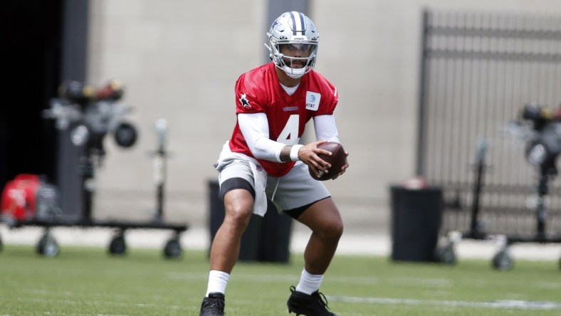 Jun 8, 2021; Frisco, TX, USA; Dallas Cowboys quarterback Dak Prescott (4) goes through drills during voluntary Organized Team Activities at the Ford Center at the Star Training Facility in Frisco, Texas. Mandatory Credit: Tim Heitman-USA TODAY Sports