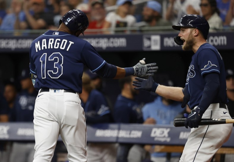 Jun 8, 2021; St. Petersburg, Florida, USA; Tampa Bay Rays right fielder Manuel Margot (13) is congratulated by designated hitter Austin Meadows (17) after he hits a home run against the Washington Nationals during the first inning at Tropicana Field. Mandatory Credit: Kim Klement-USA TODAY Sports