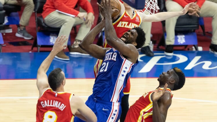 Jun 8, 2021; Philadelphia, Pennsylvania, USA; Philadelphia 76ers center Joel Embiid (21) drives for a shot against Atlanta Hawks center Clint Capela (15) and forward Danilo Gallinari (8) during the first quarter in game two of the second round of the 2021 NBA Playoffs at Wells Fargo Center. Mandatory Credit: Bill Streicher-USA TODAY Sports