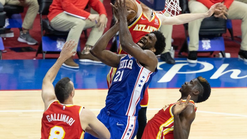 Jun 8, 2021; Philadelphia, Pennsylvania, USA; Philadelphia 76ers center Joel Embiid (21) drives for a shot against Atlanta Hawks center Clint Capela (15) and forward Danilo Gallinari (8) during the first quarter in game two of the second round of the 2021 NBA Playoffs at Wells Fargo Center. Mandatory Credit: Bill Streicher-USA TODAY Sports