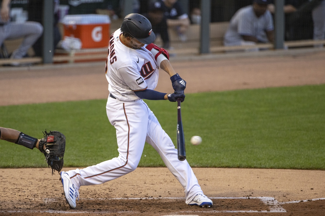 Jun 8, 2021; Minneapolis, Minnesota, USA; Minnesota Twins shortstop Andrelton Simmons (9) hits a single in the second inning against the New York Yankees at Target Field. Mandatory Credit: Jesse Johnson-USA TODAY Sports