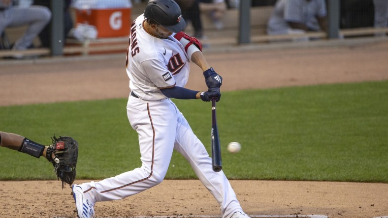 Jun 8, 2021; Minneapolis, Minnesota, USA; Minnesota Twins shortstop Andrelton Simmons (9) hits a single in the second inning against the New York Yankees at Target Field. Mandatory Credit: Jesse Johnson-USA TODAY Sports